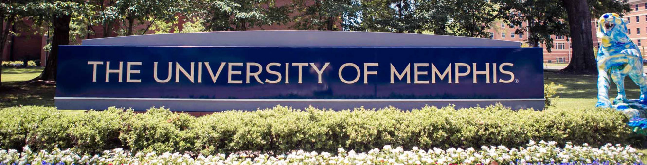Wide shot of a blue sign that says "The University of Memphis" with a blue tiger next to the sign